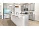 Modern kitchen features stainless steel appliances, a kitchen island with a white quartz countertop, and gray cabinets at 1716 Red Rock Rd, New Smyrna Beach, FL 32168