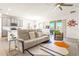 Open-concept living room with comfortable seating, sliding glass doors to the patio, and a view to the kitchen at 1716 Red Rock Rd, New Smyrna Beach, FL 32168