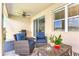 Cozy covered patio with comfortable seating and a table, perfect for outdoor relaxation at 1716 Red Rock Rd, New Smyrna Beach, FL 32168