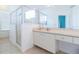 Well-lit bathroom featuring a walk-in shower, vanity with storage, and tile flooring at 1751 Creekwater Blvd, Port Orange, FL 32128