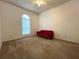 Bedroom with a bright window, carpeted flooring and red couch at 1751 Creekwater Blvd, Port Orange, FL 32128