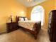 Bedroom with a bright window, a ceiling fan, and a full bedroom set at 1751 Creekwater Blvd, Port Orange, FL 32128