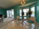 Cozy dining area with glass top table, with view of the pool and lake in a well-lit space at 1751 Creekwater Blvd, Port Orange, FL 32128
