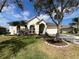 Charming home featuring a well manicured lawn, arched entryway, and beautiful landscaping at 1751 Creekwater Blvd, Port Orange, FL 32128