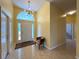 Bright foyer with tile flooring, chandelier, and a half-moon window above the front door at 1751 Creekwater Blvd, Port Orange, FL 32128