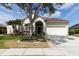 Charming single-story home featuring a well-manicured lawn, mature trees, and a welcoming two-car garage at 1751 Creekwater Blvd, Port Orange, FL 32128