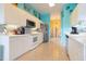 Modern kitchen featuring white cabinets, stainless steel appliances, and tile backsplash at 1751 Creekwater Blvd, Port Orange, FL 32128