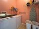 Laundry room featuring washer and dryer and storage shelving at 1751 Creekwater Blvd, Port Orange, FL 32128