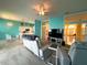 Open-concept living room with modern furnishings flowing into the kitchen and a bright entryway at 1751 Creekwater Blvd, Port Orange, FL 32128
