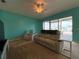Comfortable living room featuring neutral carpeting, plush reclining sofa, and views of the pool and lake at 1751 Creekwater Blvd, Port Orange, FL 32128