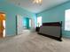Spacious main bedroom with plush carpet, and multiple doors to other spaces at 1751 Creekwater Blvd, Port Orange, FL 32128
