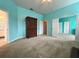 Bright main bedroom featuring plush carpet, and multiple doors to other spaces at 1751 Creekwater Blvd, Port Orange, FL 32128