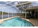 Inviting screened-in pool area with a view of the lake, perfect for outdoor entertaining and relaxation at 1751 Creekwater Blvd, Port Orange, FL 32128
