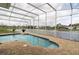 Enjoy waterfront views from this screened pool with stone decking and a lovely spillover at 1751 Creekwater Blvd, Port Orange, FL 32128