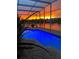 Screened-in pool with a vibrant sunset backdrop and water views at 1751 Creekwater Blvd, Port Orange, FL 32128