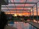 Relaxing screened-in pool area with beautiful sunset reflections at 1751 Creekwater Blvd, Port Orange, FL 32128