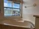 Soaking tub by the window looking out at pond and pool at 1751 Creekwater Blvd, Port Orange, FL 32128
