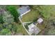 Aerial view of the property showcasing the house, backyard, outbuildings, and surrounding wooded area at 1930 S Clara Ave, Deland, FL 32720