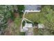 Aerial perspective of the home, highlighting backyard layout, outbuildings, and lush surrounding landscape at 1930 S Clara Ave, Deland, FL 32720
