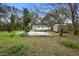 Extensive backyard showcases mature trees, lush green grass, shed and expansive space for enjoyment and recreation at 1930 S Clara Ave, Deland, FL 32720