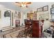 A well-decorated bar area with unique decor, a ceiling fan, and wood-look vinyl floors at 1930 S Clara Ave, Deland, FL 32720