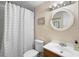 Bathroom featuring a shower with curtain, toilet, vanity with sink, and decorative mirror at 1930 S Clara Ave, Deland, FL 32720