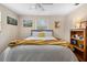 Cozy bedroom with a queen-sized bed, ceiling fan, and natural light from the windows at 1930 S Clara Ave, Deland, FL 32720