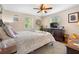 Serene bedroom featuring a queen-sized bed, ceiling fan, and natural light from the windows at 1930 S Clara Ave, Deland, FL 32720