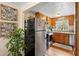 Compact kitchen with wood cabinets and stainless steel refrigerator at 1930 S Clara Ave, Deland, FL 32720