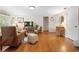 Bright living room with hardwood floors, a TV, and cozy seating arrangements at 1930 S Clara Ave, Deland, FL 32720