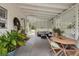 Spacious covered patio with comfortable seating, dining area, and lush plants perfect for outdoor living at 1930 S Clara Ave, Deland, FL 32720