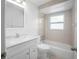 Bright bathroom with modern vanity, mirror, and shower-tub combination at 1986 Big Oak Dr, South Daytona, FL 32119