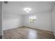 Bright bedroom with wood floors, a modern ceiling fan, and a large window at 1986 Big Oak Dr, South Daytona, FL 32119