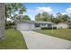 Front exterior with driveway and landscaping at 1986 Big Oak Dr, South Daytona, FL 32119