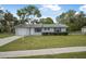 Charming single-story home with a well-maintained lawn and attached garage at 1986 Big Oak Dr, South Daytona, FL 32119