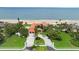 Magnificent oceanfront estate with a grand gated entrance, lush landscaping, and direct beach access at 201 Ocean Shore Blvd, Ormond Beach, FL 32176