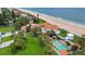 Stunning aerial view of an oceanfront home with a pool, gazebo, and beautifully manicured lawn at 201 Ocean Shore Blvd, Ormond Beach, FL 32176