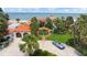 Beautiful beachfront home with lush landscaping, a circular driveway, and a classic car parked in front at 201 Ocean Shore Blvd, Ormond Beach, FL 32176