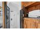 Unique bathroom features a shower with a metal-grate door, alongside wooden cabinetry with decorative objects at 201 Ocean Shore Blvd, Ormond Beach, FL 32176