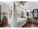 Spacious bedroom featuring a four-poster bed, decorative lamps, and stylish decor at 201 Ocean Shore Blvd, Ormond Beach, FL 32176