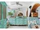 Turquoise bedroom vanity with mirror, decorative accents, and chair creates an inviting and stylish space at 201 Ocean Shore Blvd, Ormond Beach, FL 32176