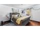 Comfortable bedroom with a tufted headboard, decorative lights, and charming faux ivy accents at 201 Ocean Shore Blvd, Ormond Beach, FL 32176