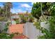 Inviting courtyard with red brick design, framed by a white fence and lush greenery at 201 Ocean Shore Blvd, Ormond Beach, FL 32176