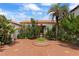A lush courtyard with tiled flooring, a fountain, and mature plantings create a tranquil retreat at 201 Ocean Shore Blvd, Ormond Beach, FL 32176