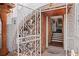 Ornate wrought iron gate leading to the entryway of the house, showcasing wooden doors and brick flooring at 201 Ocean Shore Blvd, Ormond Beach, FL 32176