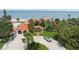 Beautiful home with terracotta roof tiles and a circular driveway, showcasing the lush landscaping at 201 Ocean Shore Blvd, Ormond Beach, FL 32176
