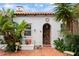 Cozy courtyard with brick flooring and a decorative entryway filled with firewood at 201 Ocean Shore Blvd, Ormond Beach, FL 32176