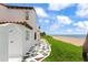 Beach house exterior with coastal charm, featuring a stone path, outdoor shower, and ocean views at 201 Ocean Shore Blvd, Ormond Beach, FL 32176
