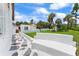 This home's unique stone path leads to a peaceful exterior with palm trees and a glimpse of the charming architecture at 201 Ocean Shore Blvd, Ormond Beach, FL 32176