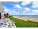 Picturesque beachfront home with a unique stone patio offering breathtaking ocean views and a lush lawn at 201 Ocean Shore Blvd, Ormond Beach, FL 32176